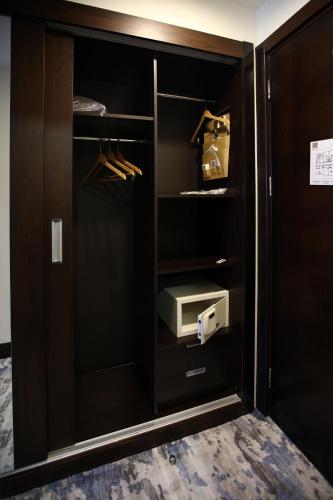 a closet with a black cabinet with a drawer at Baia Bursa Hotel in Bursa