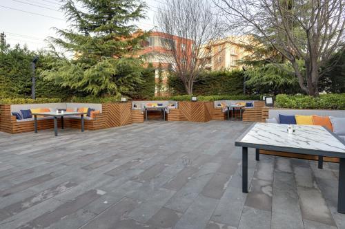 a patio with tables and chairs in a park at Leo Suites in Bursa