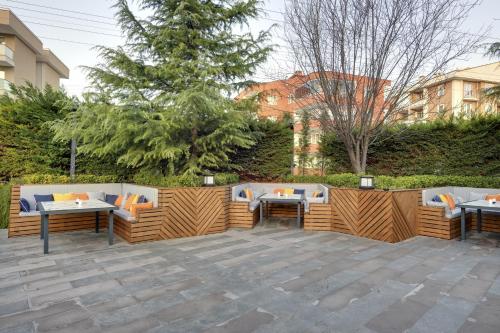 a patio with tables and chairs and a fence at Leo Suites in Bursa