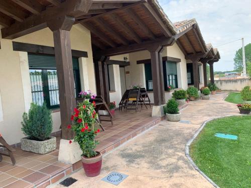 a porch of a home with a wooden pergola at La Senda Del Duratón in Sebúlcor