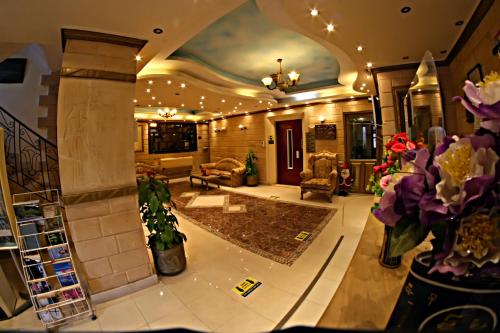 a large living room with a lobby with flowers at Luxor Hotel Hurghada in Hurghada