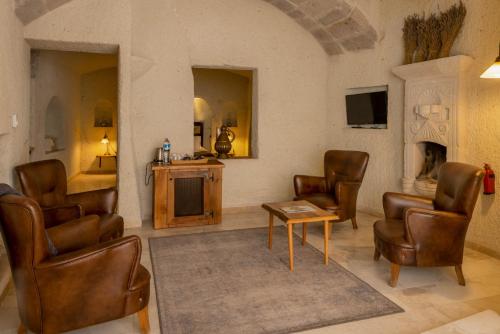 a waiting room with chairs and a table and a tv at Seki Cave Suites in Goreme
