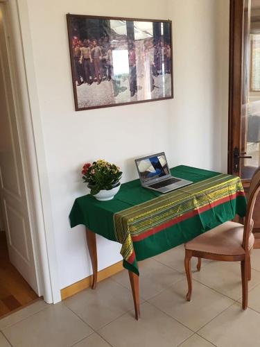 a table with a laptop sitting on top of it at Casa Vista Lago 154 SQM in Passignano sul Trasimeno