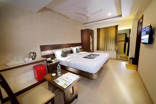 a hotel room with a bed and a television at HOTEL THE FORTUNE in Coimbatore