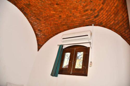 a small window in a building with a roof at Om-Abdallah in Aswan