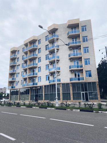 a large apartment building on the side of a street at Hotel Horizont! in Batumi