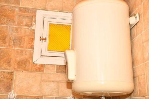 a toilet in a bathroom with a window at Om-Abdallah in Aswan