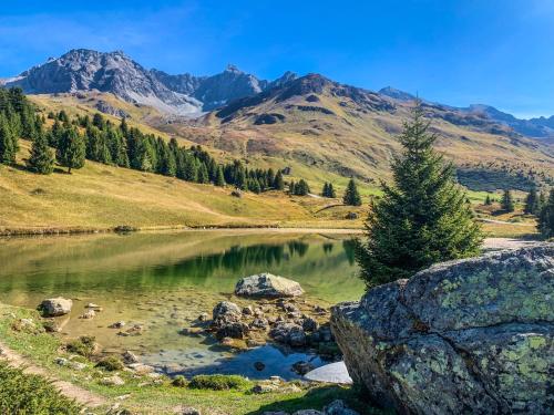 a lake in the mountains with mountains in the background at Ferienwohnung in den Bergen mit grosser Terrasse in Bivio