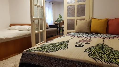 a bedroom with a bed and a living room at Lend two room house in Miercurea-Ciuc