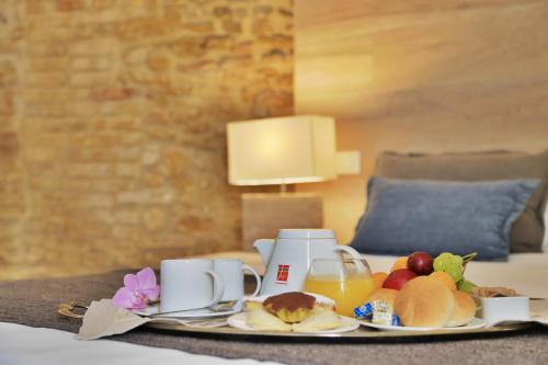 a tray of breakfast food on a table in a hotel room at Residenza Amblingh in Vasto