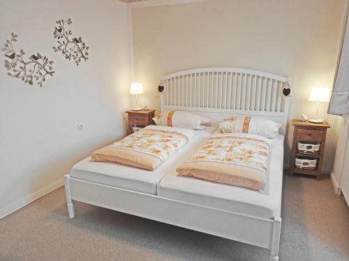 a white bed with two pillows on it in a bedroom at Haus Maria Elisabeth in Mittenwald
