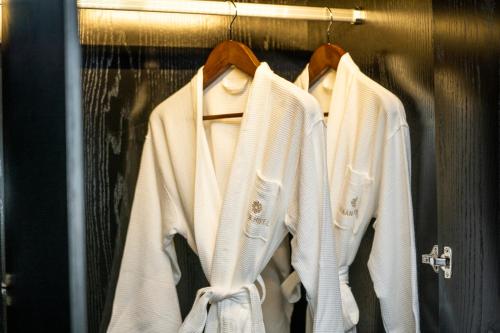 a group of white sweaters hanging in a closet at OCEAN HOTEL in Phnom Penh