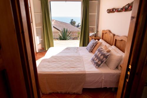 a bedroom with a bed with a view of the ocean at VILLA BINIBECA LIFE in Binibeca