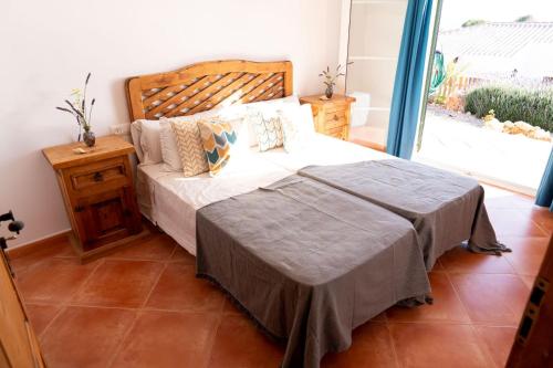 a bedroom with a large bed and a window at VILLA BINIBECA LIFE in Binibeca