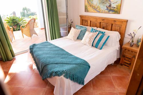 a bedroom with a bed with a blue blanket on it at VILLA BINIBECA LIFE in Binibeca
