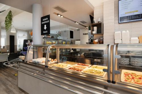 a bakery counter with a lot of food on display at Willa 777 Krasickiego in Międzyzdroje