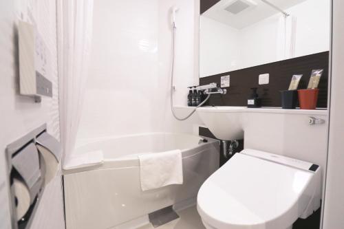 a bathroom with a toilet and a sink and a mirror at M's Hotel Sanjo Wakoku in Kyoto