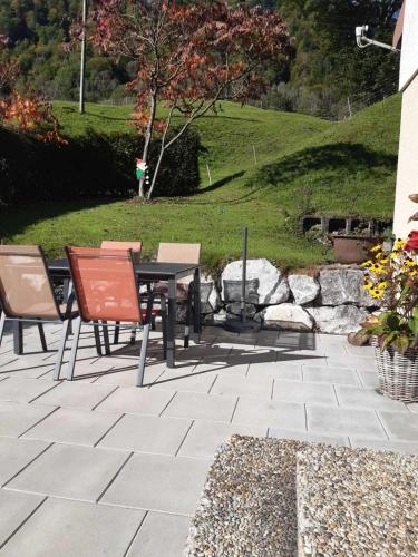 a patio with a table and chairs on a patio at Ferienhus Klus 415 in Mellau