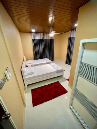 a bedroom with a bed and a red rug at BUNGALOW D'CENANG- Private Pool in Pantai Cenang