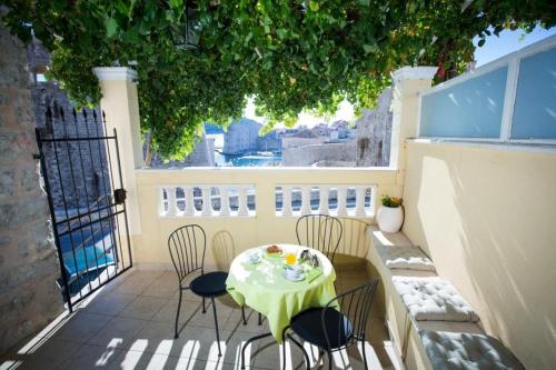 a table and chairs sitting on a balcony with a table at Apartment Nera in Dubrovnik