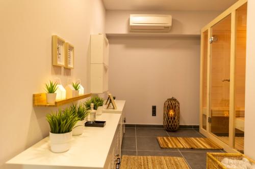 a bathroom with a counter with plants on it at Athenian Riviera Hotel& Suites in Athens