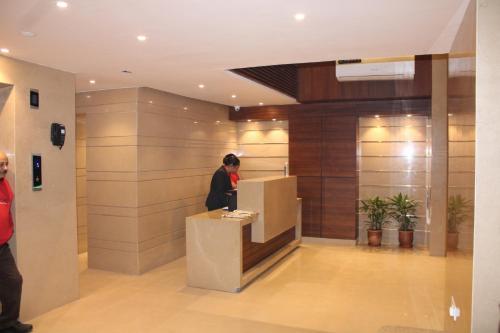 a man standing at a counter in a lobby at Sagar Hotel JUST 5 MIN FROM GOLDEN TEMPLE in Amritsar