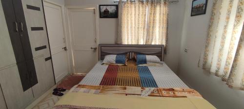 a small bedroom with a bed in a room at ''Go Desert'' Homestay in Bhuj