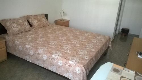 a bedroom with a large bed in a room at House of Flowers in Ahtopol