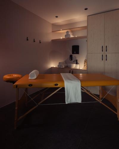 a large wooden table in a room with a bed at Triangel Boutique Hotel in Kranjska Gora
