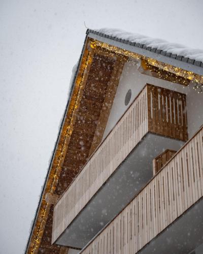 a building with snow on the roof of it at Triangel Boutique Hotel in Kranjska Gora