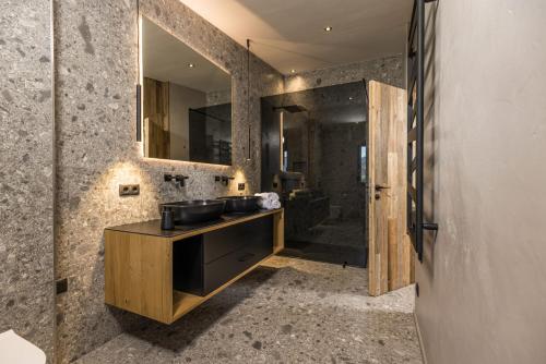 a bathroom with a sink and a mirror at Perfect Lodgings Panorama in Hart im Zillertal