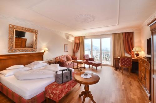 a hotel room with a bed and a mirror at Hotel MARIA THERESIA adults-only in Lagundo