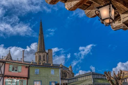 a church with a steeple in the background at Superbe appartement plein centre, calme, Netflix in Mirepoix