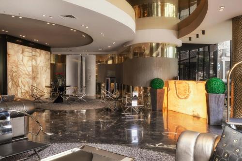 a lobby of a hotel with a reception desk at Hotel Emirates in Sofia