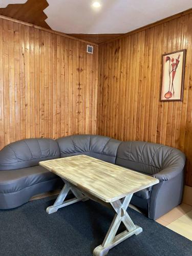 a living room with a leather couch and a table at Lemon in Drohobytsch