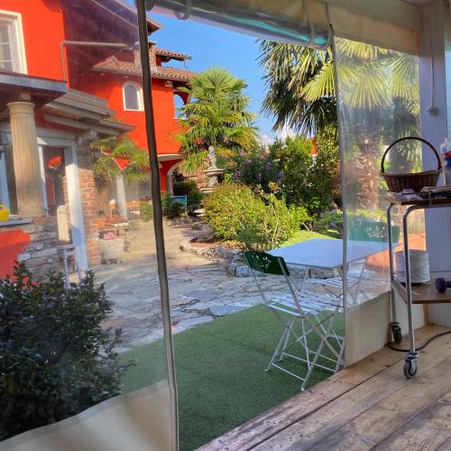 a patio with a table and chairs on a porch at B&B Villa Botto in Cossato