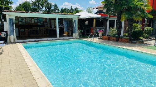a swimming pool in front of a house at B&B Villa Botto in Cossato