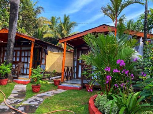 a house with a garden in front of it at Salida del Sol Patnem in Patnem