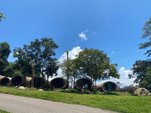 a group of round houses in a park at The Rock Lodge in Ban Nahin-Nai (1)