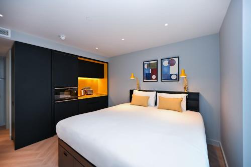 a bedroom with a large white bed with two pillows at Staycity Aparthotels Dublin Mark Street in Dublin