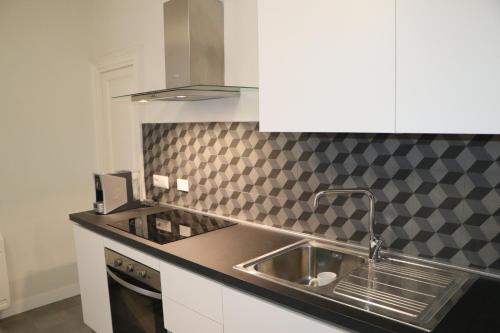 a kitchen with a sink and a counter top at DOMUS IOLE appartamento nel centro storico in Catania