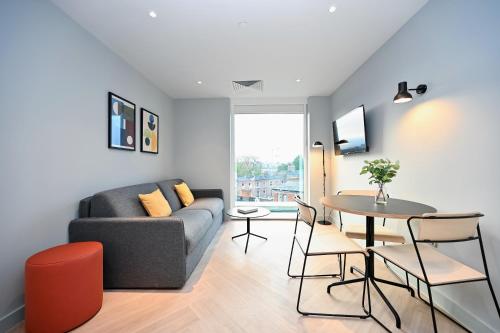 a living room with a couch and a table at Staycity Aparthotels Dublin Mark Street in Dublin
