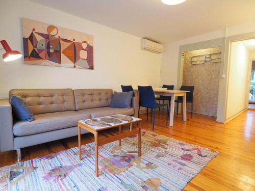 a living room with a couch and a table at Bela Vista - Lissabon Altstadt in Lisbon