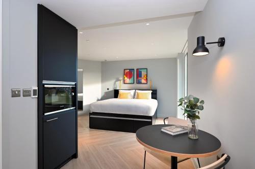 a bedroom with a bed and a table in a room at Staycity Aparthotels Dublin Mark Street in Dublin