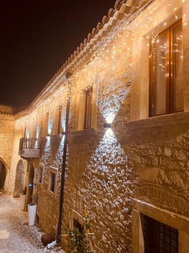 a stone building with lights on it at night at RELAIS SAN MARCO LUXURY GUEST HOUSE in Volturino