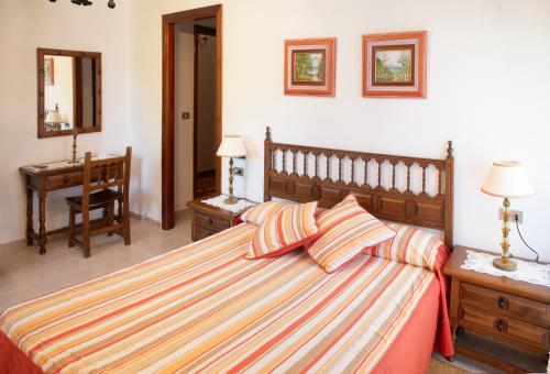 a bedroom with a large bed with two pillows at Casa Ravel in Silleda