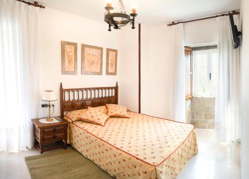 a bedroom with a bed and a window at Casa Ravel in Silleda