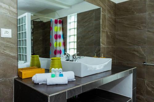 a bathroom with a sink and a mirror at The Sanctuary MADAGASCAR in Foulpointe