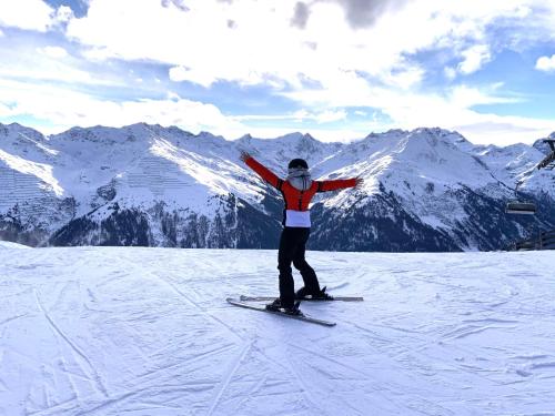 a person on skis standing on a snow covered mountain at K-Appartements Klösterle in Klösterle am Arlberg