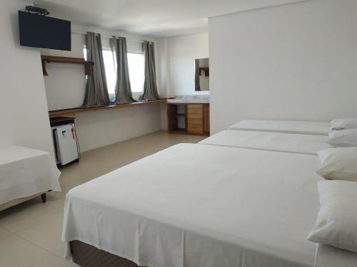 Hotel Lírio tesisinde bir odada yatak veya yataklar